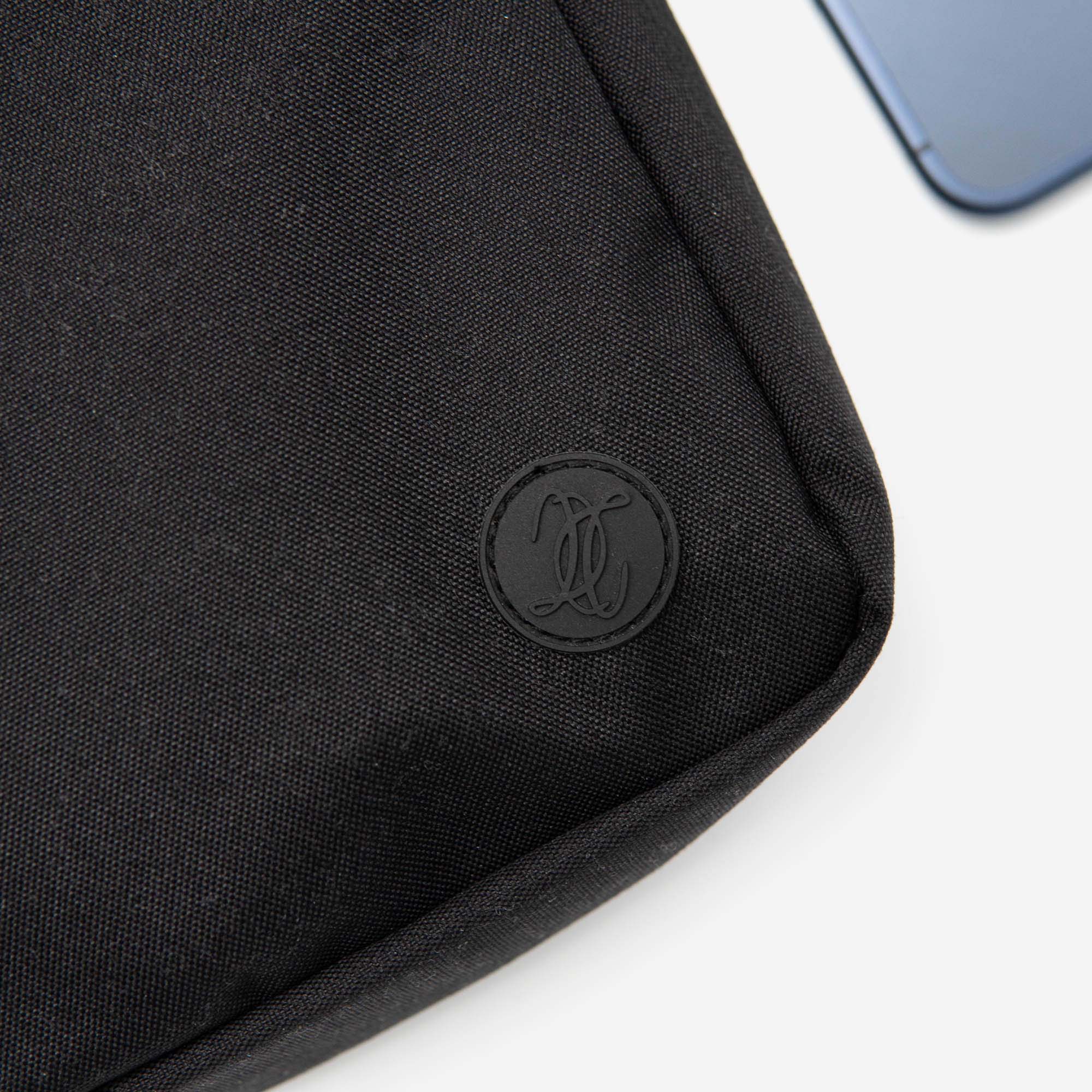 Black fabric sleeve with a logo on a white background